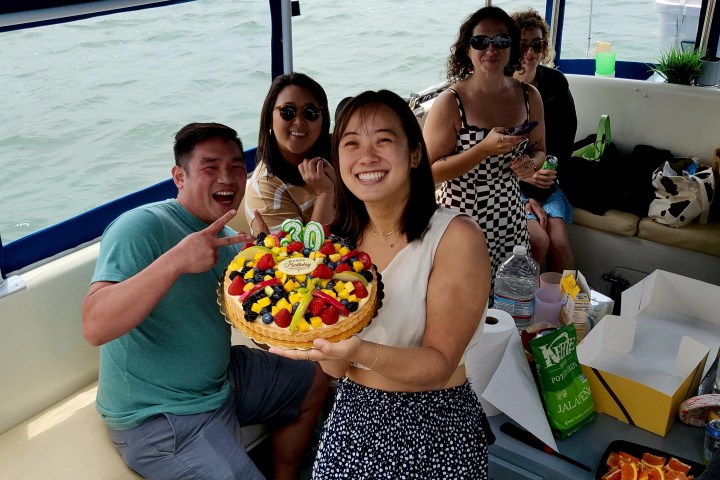 a woman holding a birthday cake