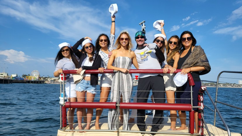 a group of people standing next to a body of water